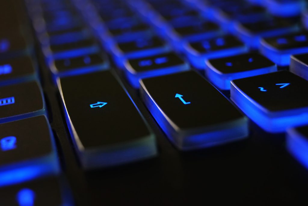 LearnOnline Fast Track Computer Science A level Self-study Close up of computer keyboard with blue lighting