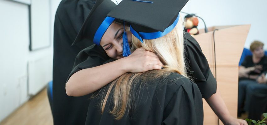 LearnOnline UCAS - two people in graduation cap and gown hugging