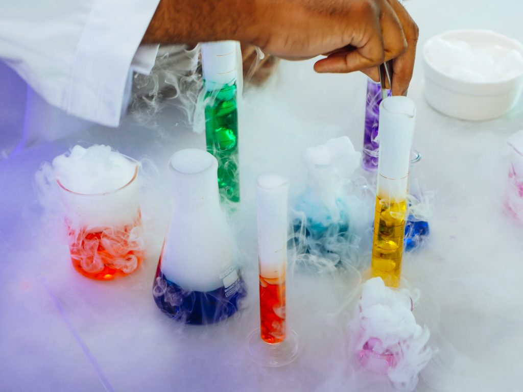 LearnOnline Live Chemistry IGCSE Several test tubes and beakers with colourful liquid and smoke