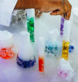 LearnOnline Live Chemistry IGCSE Several test tubes and beakers with colourful liquid and smoke