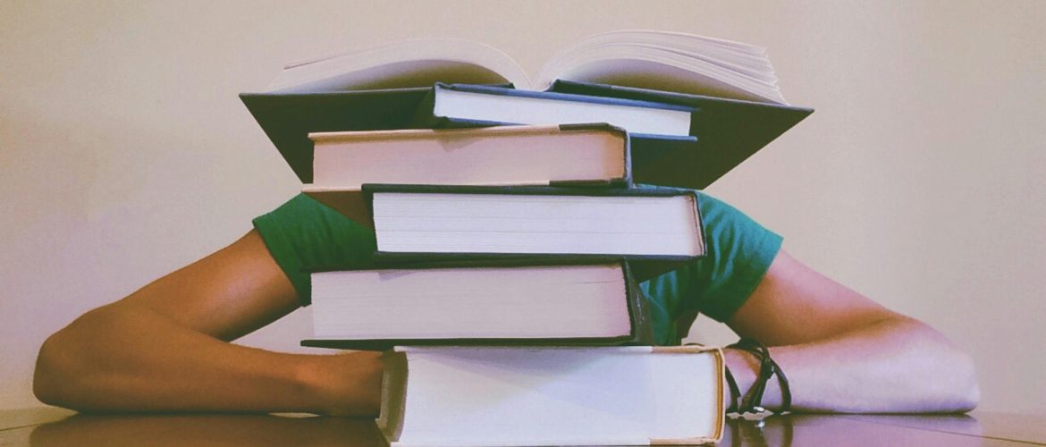 LearnOnline Course Packages: pile of books with someone behind