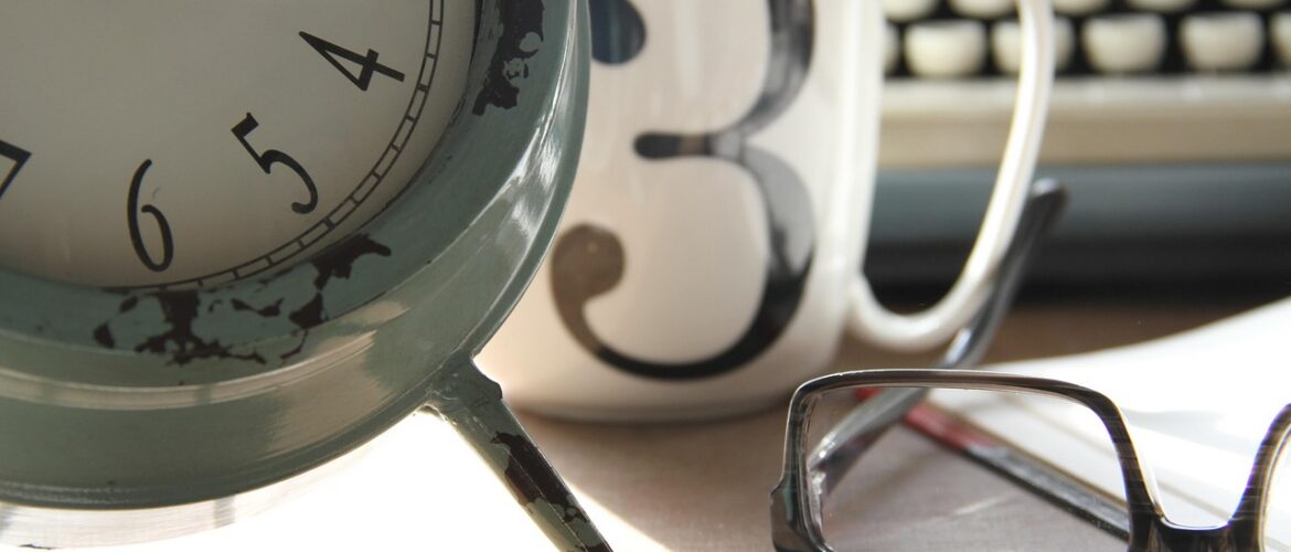 Image of clock, mug, glasses and typewriter