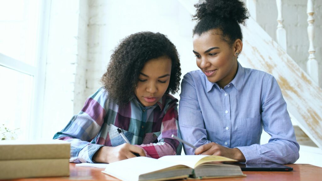 Parent and child studying at a desk