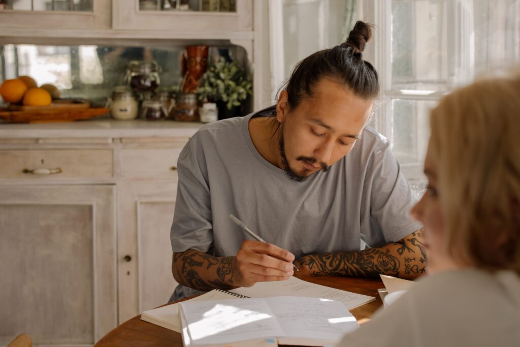 Adult studying at a table in kitchen